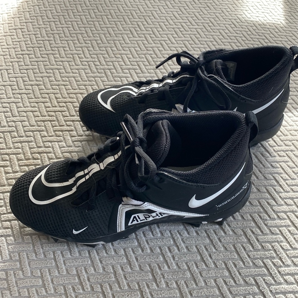 Youth Nike Black Mid top cleats. Size youth 4.5. Excellent Condition.
